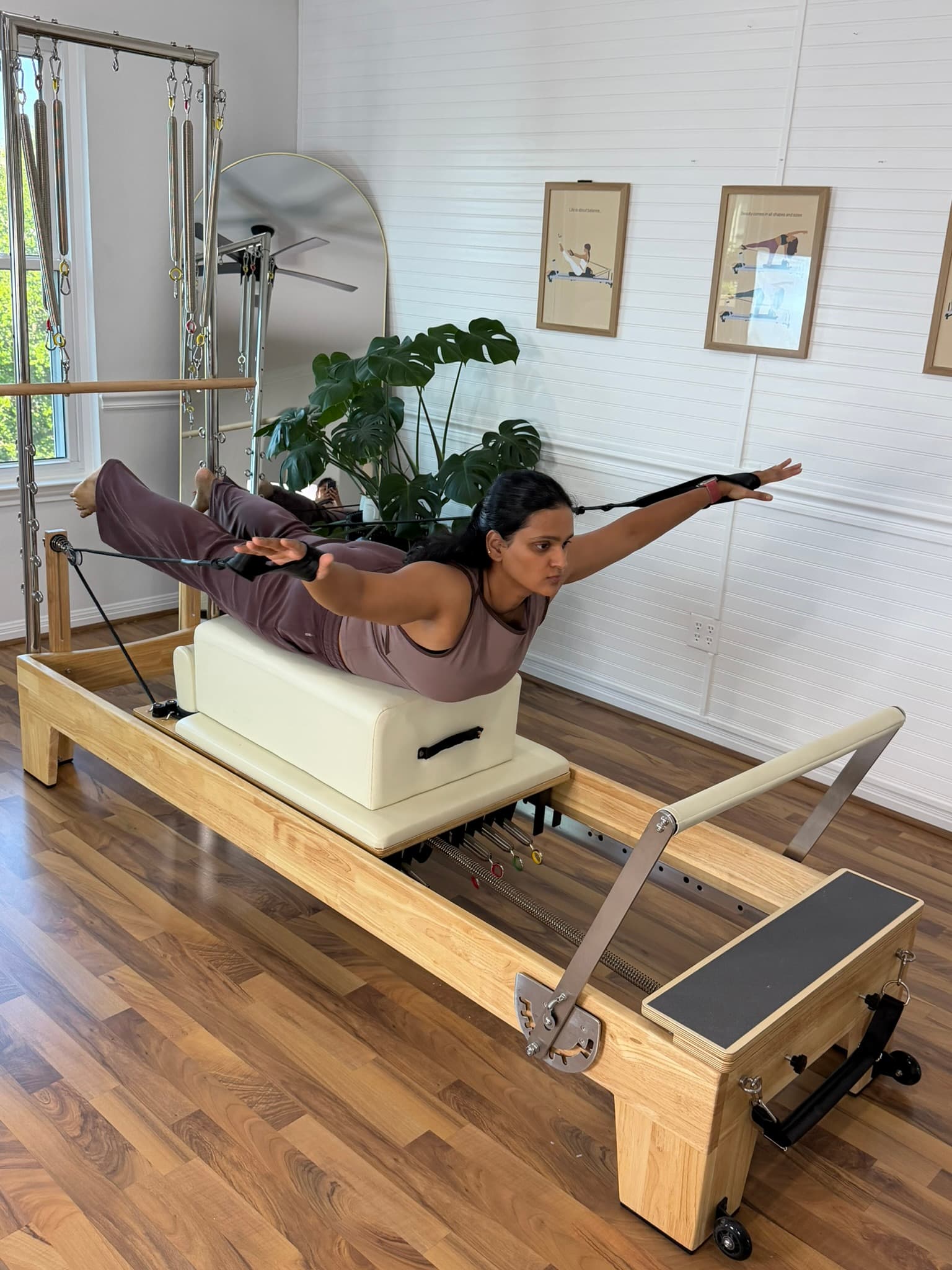 Pilates instructor demonstrating a Contrology move